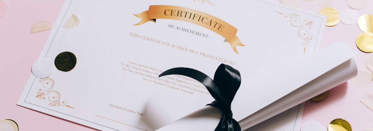 Certificate and diploma in centre focus with pink background and gold confetti