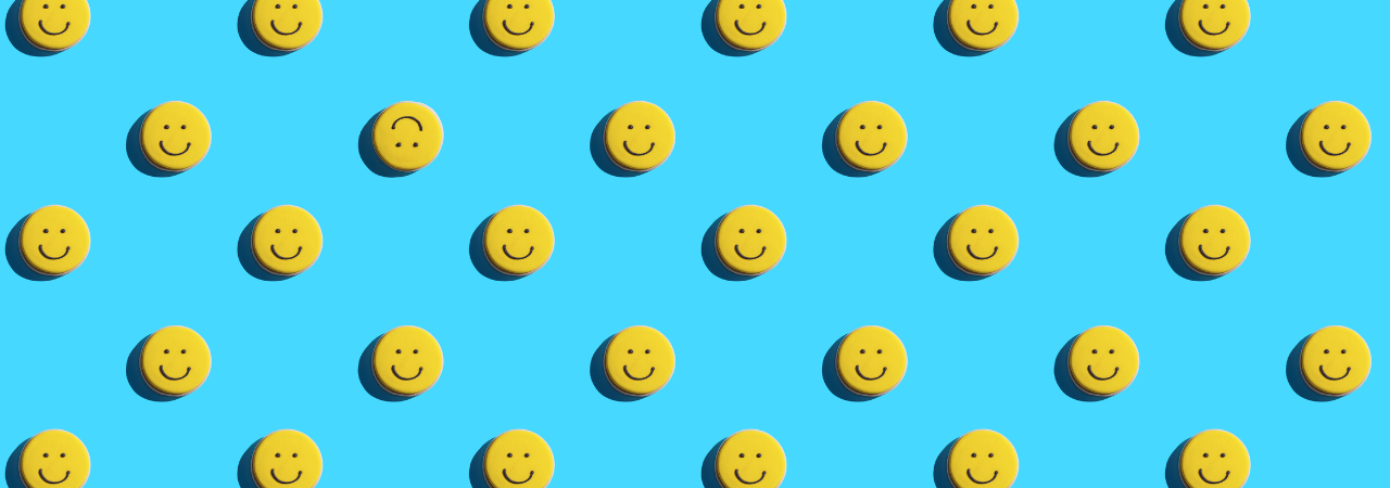 blue background with yellow smiley face motif